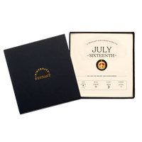 The July Sixteenth Pendant inside its box